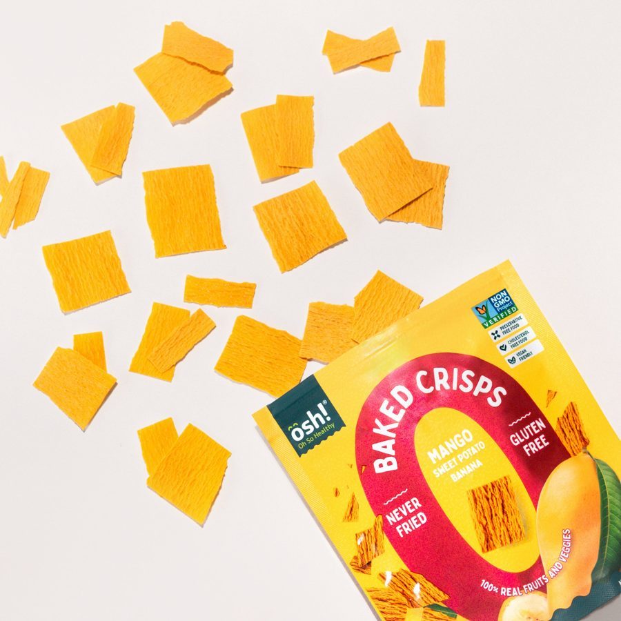 Mango crisps scattered beside an open Mango pack