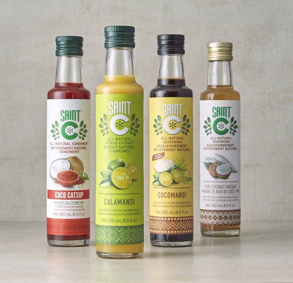 The four Saint C bottles standing in a row: Coco Catsup, Calamansi, Cocomansi and Pure Coconut Vinegar