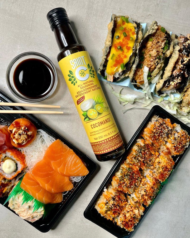 Saint C Cocomansi bottle among sushi, sashimi and nori tacos